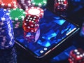 A gambling setup on a digital tablet featuring an array of colorful poker chips and red dice, with a green felt Royalty Free Stock Photo