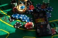 Gambling theme. Colorful playing chips in stacks on green table close up