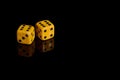 Gambling. Two dice on a black background with reflection Royalty Free Stock Photo