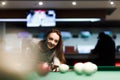 Gambling woman plays snooker in a billiards club Royalty Free Stock Photo