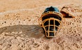 A game of baseball can fix any mood. a catchers helmet lying on a baseball field. Royalty Free Stock Photo