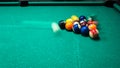 game of billiards with colored and numbered balls. 8 ball. green table and moving balls with billiard cue. panning the Royalty Free Stock Photo