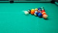 game of billiards with colored and numbered balls. 8 ball. green table and moving balls with billiard cue. panning the Royalty Free Stock Photo