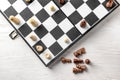 Game board with chess pieces on white wooden table Royalty Free Stock Photo