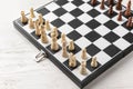 Game board with chess pieces on white wooden table Royalty Free Stock Photo