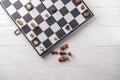 Game board with chess pieces on white wooden table Royalty Free Stock Photo