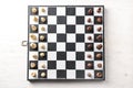 Game board with chess pieces on white wooden table Royalty Free Stock Photo