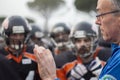 Awesome portrait of an American football coach who is instructing his players during half-time Royalty Free Stock Photo