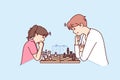 Game of chess between man and teenage girl during training of professional grandmaster