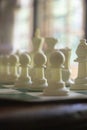 A game of chess in play with black and ivory pieces. Royalty Free Stock Photo