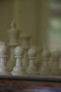 A game of chess in play with black and ivory pieces. Royalty Free Stock Photo