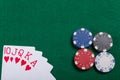 Game chips and cards on the green poker table. A winning combination in Royal Flush poker Royalty Free Stock Photo