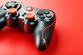 Game controller controller on red background. Device to control and control the game. close up Royalty Free Stock Photo