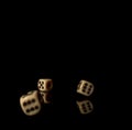 Game cubes on shiny black table with dark reflection Royalty Free Stock Photo