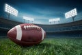 Game day essence captured with Closeup American football on lush field under stadium lights Royalty Free Stock Photo