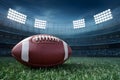 Game day essence captured with Closeup American football on lush field under stadium lights Royalty Free Stock Photo