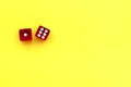 Two red dice lie on a yellow background with space for text. Royalty Free Stock Photo