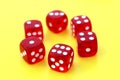Six red dice lie on an isolated background.