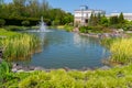 Game fountain over an artificial lake in a botanical garden in front of the terrace of the house Royalty Free Stock Photo