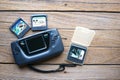 Game Gear on wooden background. Royalty Free Stock Photo