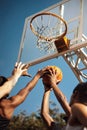 The game is getting tense. Closeup shot of a group of sporty young men playing basketball on a sports court. Royalty Free Stock Photo