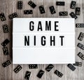 Game night text frame of dominoes with copy space inside on wooden background, table game Royalty Free Stock Photo