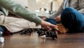 Game over. Chess figures on the floor, selective focus, little boy playing chess with grandfather at home