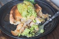 Game pie with duck meat in serving dish with peas puree, spinach and vintage fork close up