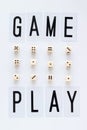 GAME PLAY words and gaming dice in row on white background.