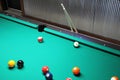 A Game of Pool In Progress with Cues