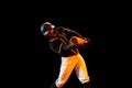 American baseball player, pitcher in sports uniform and equipment playing baseball isolated on black studio background