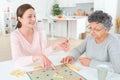 Game scrabble with old woman