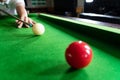 Game snooker billiards or opening frame player ready for the ball shot, athlete man kick cue on the green table in bar Royalty Free Stock Photo