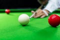 Game snooker billiards or opening frame player ready for the ball shot, athlete man kick cue on the green table in bar Royalty Free Stock Photo