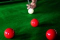 Game snooker billiards or opening frame player ready for the ball shot, athlete man kick cue on the green table in bar Royalty Free Stock Photo