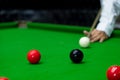 Game snooker billiards or opening frame player ready for the ball shot, athlete man kick cue on the green table in bar Royalty Free Stock Photo