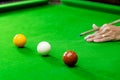 Game snooker billiards or opening frame player ready for the ball shot, athlete man kick cue on the green table in bar Royalty Free Stock Photo