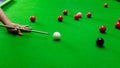 Game snooker billiards or opening frame player ready for the ball shot, athlete man kick cue on the green table in bar Royalty Free Stock Photo