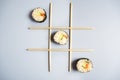 Game tic-tac-toe with chopsticks for food and sushi