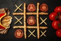 Game of tic tac toe of french fries and tomatoes. Choosing healthy vs unhealthy foods. Fit or fat concept