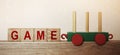 Game word on wooden cubes, and toy train. Business concept background