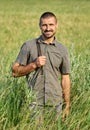 Gamekeeper with a rifle in a field