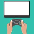 Gamepad in hands in front of blank tv screen