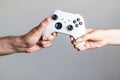 The gamepad is in the hands of a man and a woman Royalty Free Stock Photo