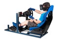 Gamer in blue tshirt with VR virtual reality glasses training on simracing aluminum simulator rig for video game racing. Royalty Free Stock Photo