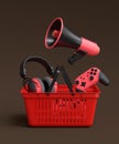 Gamer gears like headset, headphones and joystick in plastic basket on dark