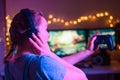 Gamer girl with a joystick plays on a console or computer using a gamepad, controller, joystick. Against the background of three Royalty Free Stock Photo