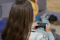 Gamer girl playing video games with joystick sitting on Bean bag chair Royalty Free Stock Photo