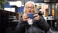Gamer grandmother playing video game on smartphone