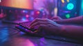 A gamer, hands on a colorful keyboard vibrant lights high-performance gaming setup